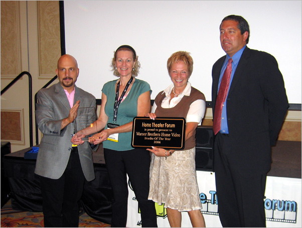 Ron presents an award to Warner's Janet Keller, Ronnee Sass and Steve Nickerson