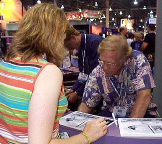 Brown signs an autograph.